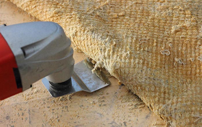 Surface prep by removing an old carpet with an electric tool