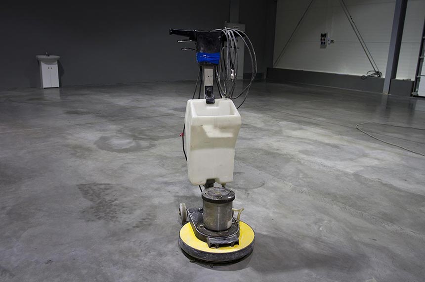 Grinding machine on a concrete surface after floor preparation