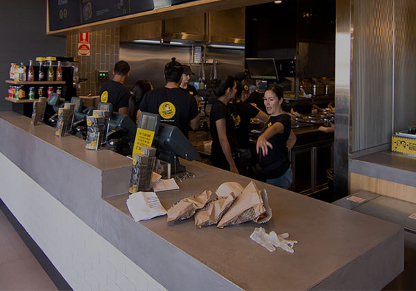 Custom-shaped cashier concrete benchtop for restaurant